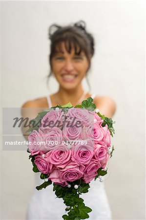 Bride Holding Bouquet of Pink Roses