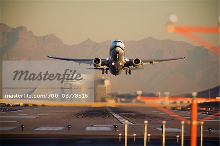 Airplane Taking Off at Sunset