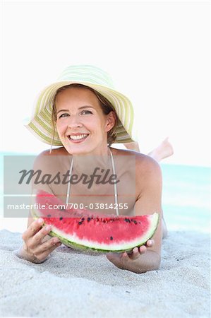 Woman Eating Watermelon on Beach