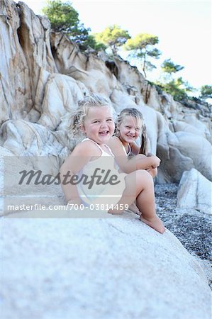 Sisters Sitting on Rocks
