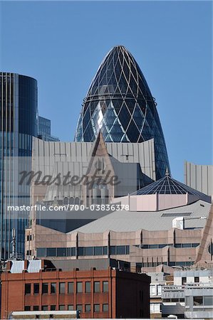 Swiss Re Tower Peeking Out from Behind Buildings, London, England