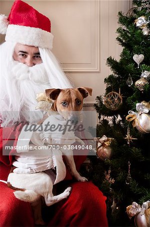 Santa Claus Holding Dog on Lap