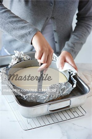 Woman Cutting Edge of Cheesecake with Knife Woman Cutting Edge of Cheesecake with Knife