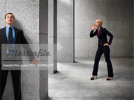 Businessman Hiding from Businesswoman