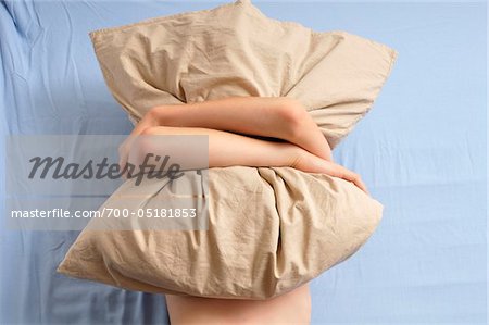 Boy Hugging Pillow in Bed
