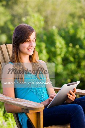 Teenage Girl Using iPad Outdoors
