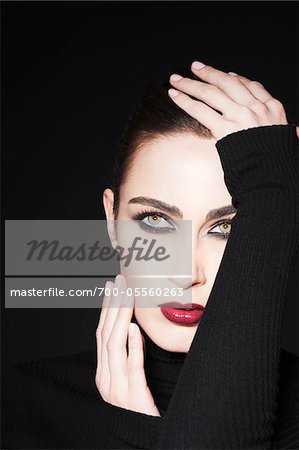 Woman in Studio Touching Face Woman in Studio Touching Face