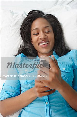 Woman Using Phone in Bed