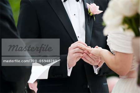 Bride and Groom Exchanging Rings during Wedding Ceremony