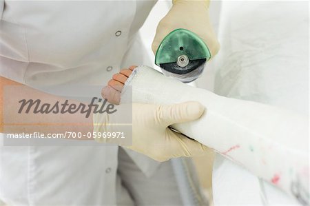 Nurse Cutting Child's Leg Cast