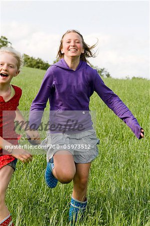 Two Girls Running in Field Two Girls Running in Field