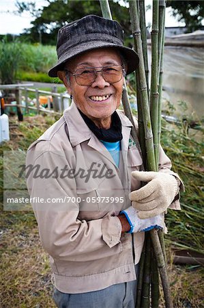 Portrait of Man Holding Pieces of Bamboo, Inutabu, Tokunoshima Island, Kagoshima Prefecture, Japan Portrait of Man Holding Pieces of Bamboo, Inutabu, Tokunoshima Island, Kagoshima Prefecture, Japan