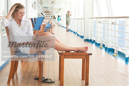 Teenage Girl Reading Book on Cruise Ship