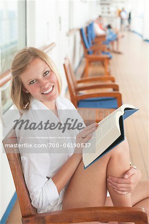 Teenage Girl Reading Book on Cruise Ship Deck