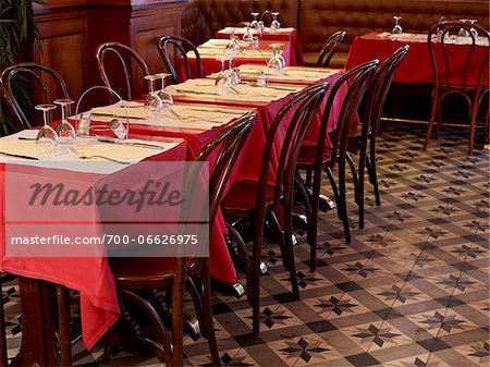 tables set with red tablecloths, wine glasses and cutlery in restaurant, Paris, France