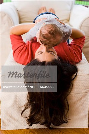 Woman Lying Down and Snuggling with her Three Month Old Son