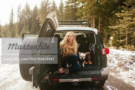 Portrait of Woman with her French Bulldog in the Back of an FJ Cruiser SUV on Mt. Hood, Oregon, USA