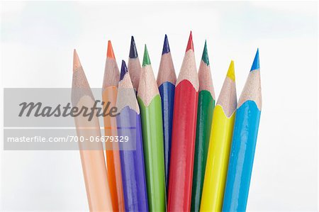 Close Up of Ten Multi-Colored Pencil Crayons on White Background