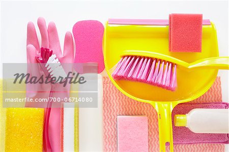 still life of cleaning products including sponges, plastic bottle, rubber gloves, dustpan, and hand broom