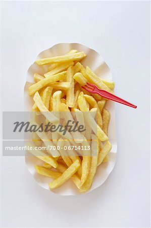 still life of french fries with plastic fork