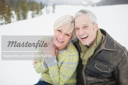 Portrait of couple laughing in the snow.