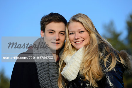 Portrait of Young Couple Wearing Jackets and Scarves Outdoors in Autumn, Bavaria, Germany