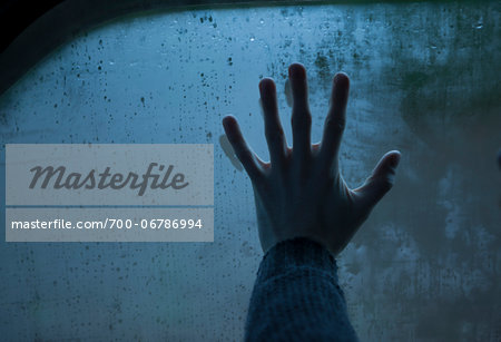 Hand on wet window. Hand on wet window.