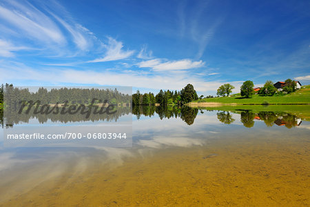 Landscape and Sky Reflecting in Lake Hegratsrieder See in Spring, Hegratsried, Halblech, Swabia, Bavaria, Germany