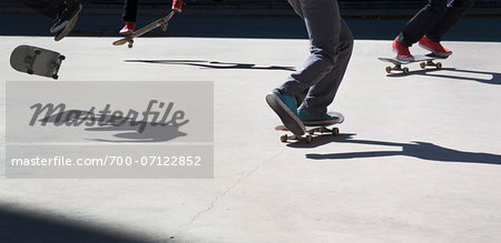 Close-up of multiple skateboarders practicing moves, downtown Toronto, Ontario, Canada