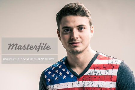 Portrait of Young Man wearing American Flag Tee Shirt, Studio Shot