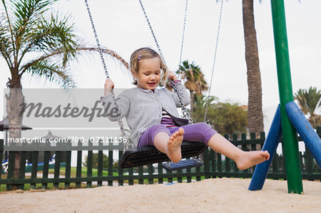 Bare Feet of a Little Girl Hanging in the Air Stock Image - Image