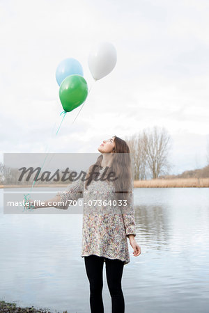 Portrait of Young Woman Outdoors with Balloons, Mannheim, Baden-Wurttemberg, Germany