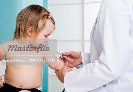 Doctor about to give Baby Girl an Injection in Doctor's Office