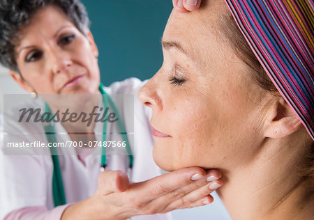 Doctor touching Woman's Face