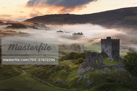 Dolwyddelan Castle, Snowdonia National Park, North Wales. Ruined castle in a misty, mountainous landscape at dawn.