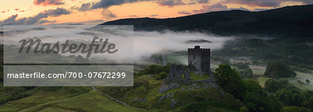 Dolwyddelan Castle, Snowdonia National Park, North Wales. Ruined castle in a misty, mountainous landscape at dawn.