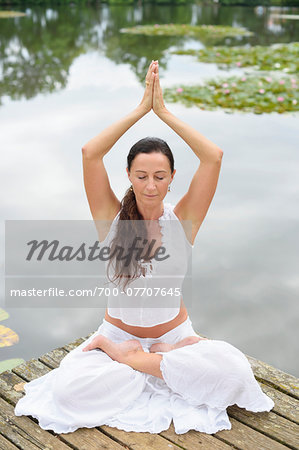 Mature Woman doing Yoga in Park in Summer, Bavaria, Germany