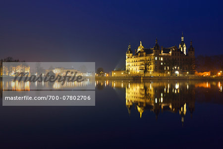 Schwerin Castle reflected in lake at night, Schwerin, Western Pomerania, Germany