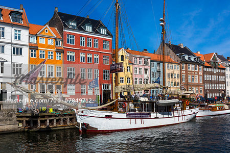 Historical, wooden sailing ship docked at waterfront, Nyhavn Harbour, Copenhagen, Denmark Historical, wooden sailing ship docked at waterfront, Nyhavn Harbour, Copenhagen, Denmark