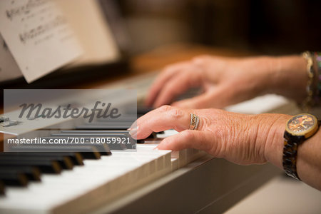 Close-up of Person's Hands Playing Piano