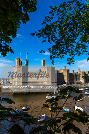 Boats at low tide in front of Caernarfon Castle, Caernarfon, Gwynedd, Wales, United Kingdom Boats at low tide in front of Caernarfon Castle, Caernarfon, Gwynedd, Wales, United Kingdom