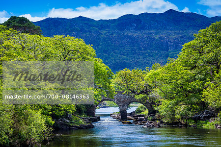 Scenic view of lake with stone, arch bridge, Killarney National Park, beside the town of Killarney, County Kerry, Ireland