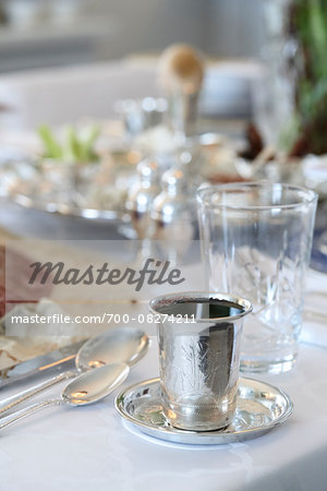 Filled Wine Cup in Passover Table Setting with Seder Plate in the background