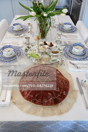 Fully Set Passover Seder Table with Seder Plate and Matzah Cover