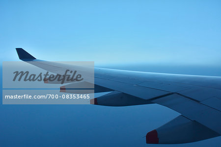 Close-up view of aircraft wing of Airbus A380, during flight over Indonesia at Dusk
