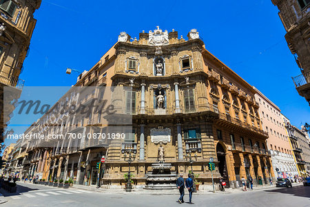 Tourists sightseeing in front of of the North building at Piazza Vigliena (Quattro Canti) on Corso Vittorio Emanuele in Palermo, Sicily in Italy