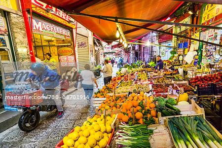 People shopping in the historic, open-air Vucciria Market in Palermo city in Sicily, Italy