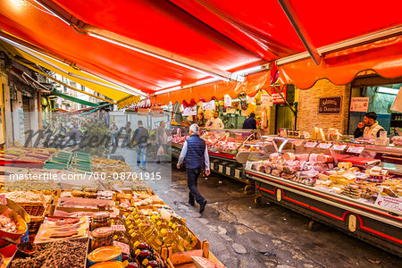 People walking through the ancient, open-air Ballaro Market in the old town in Palermo, Sicily, Italy