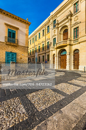 Stone buildings and inlayed designs in the cobblestone streets of Noto in the Province of Syracuse in Sicily, Italy