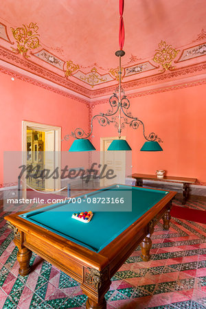 Room with pink walls and billiard table inside the Palazzo Nicolaci in Noto in the Province of Syracuse in Sicily, Italy